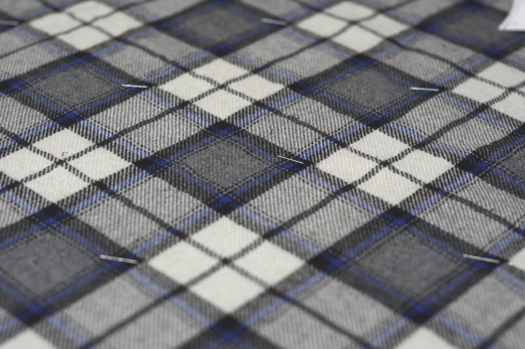 Aligning the plaid wool fabric.