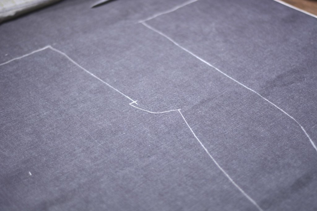 Jeans pattern laid out on cloth.
