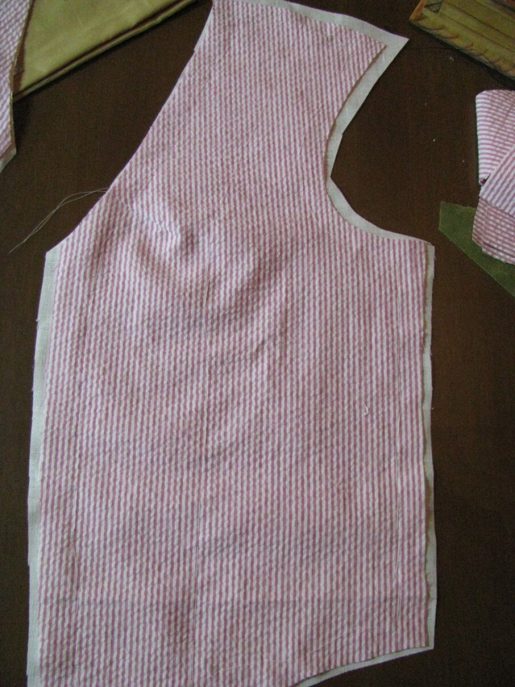 The waistcoat forepart attached to the canvas.