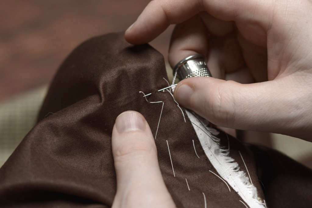 Stitching a pocket bag closed.